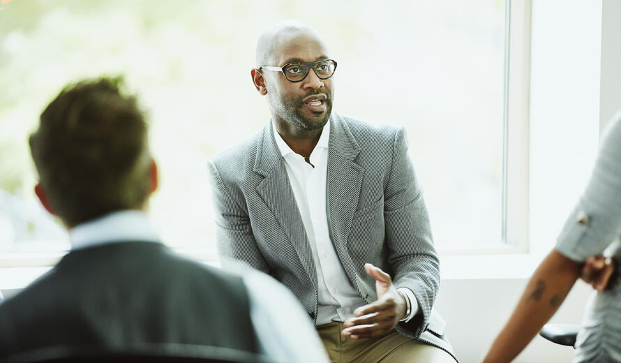 Businessman leading team informal team meeting in office