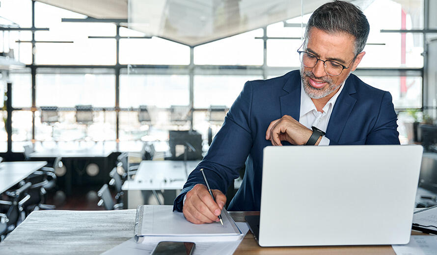 A man with laptop computer in the office.