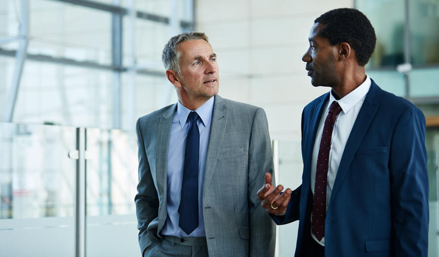 two men in suits walking